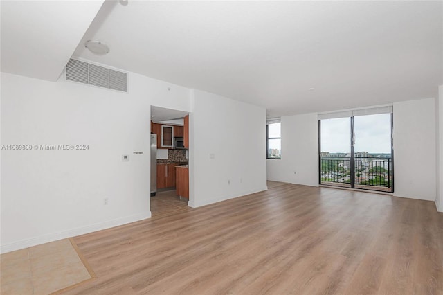 unfurnished living room with light hardwood / wood-style flooring