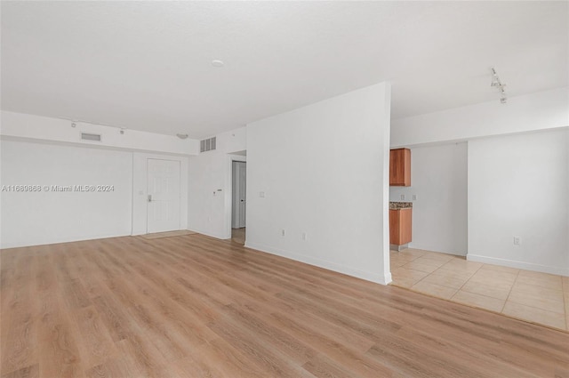 empty room with light hardwood / wood-style floors