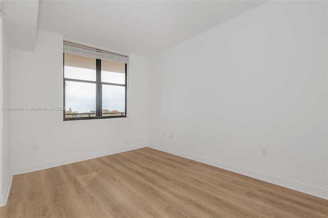 spare room with light hardwood / wood-style flooring