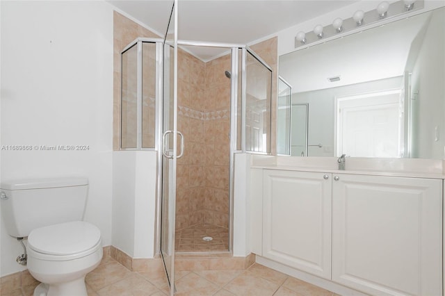 bathroom with toilet, sink, tile patterned flooring, and a shower with shower door