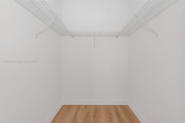 walk in closet with wood-type flooring