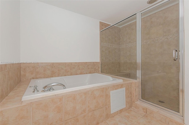 bathroom with plus walk in shower and tile patterned flooring