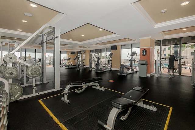 gym featuring crown molding and a tray ceiling