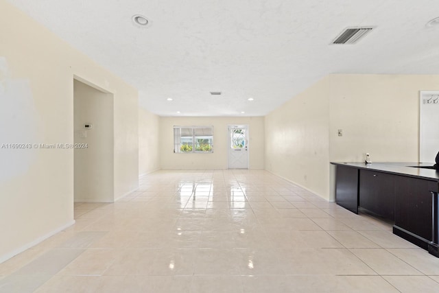 unfurnished living room featuring light tile patterned floors