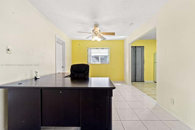 tiled office space featuring ceiling fan