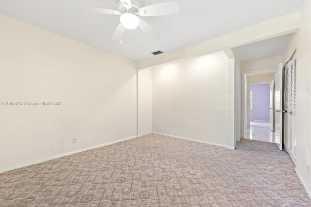 empty room featuring light carpet and ceiling fan