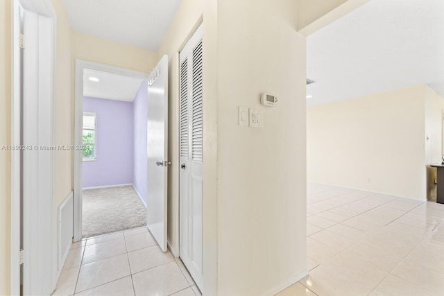 hallway with light colored carpet