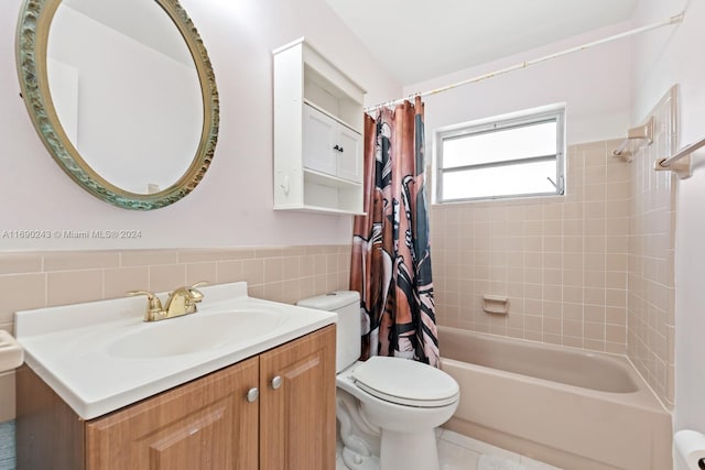 full bathroom with tile walls, vanity, shower / bath combo with shower curtain, and tile patterned floors