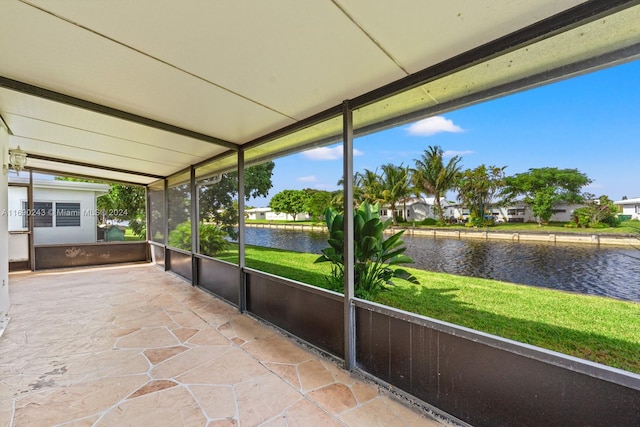 unfurnished sunroom with a water view