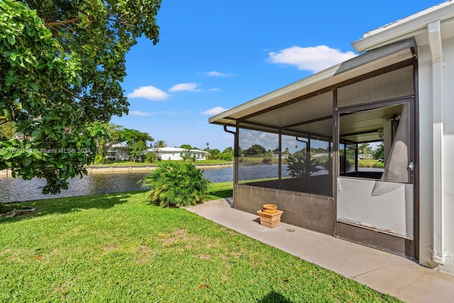 view of yard with a water view and a sunroom