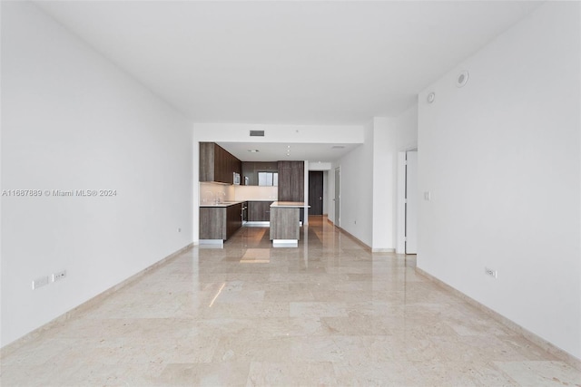 unfurnished living room featuring sink