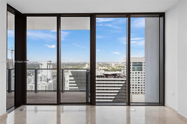 empty room featuring expansive windows and plenty of natural light