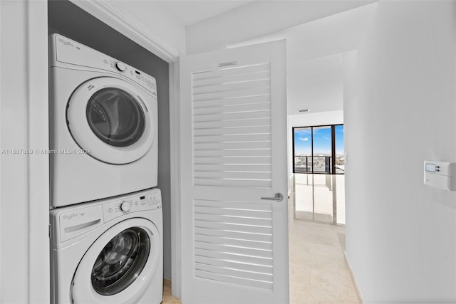 clothes washing area featuring stacked washing maching and dryer and light tile patterned floors