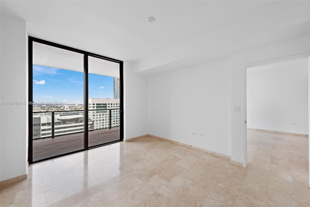 unfurnished room with floor to ceiling windows