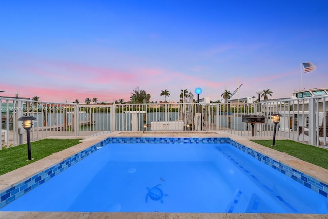 pool at dusk with a water view