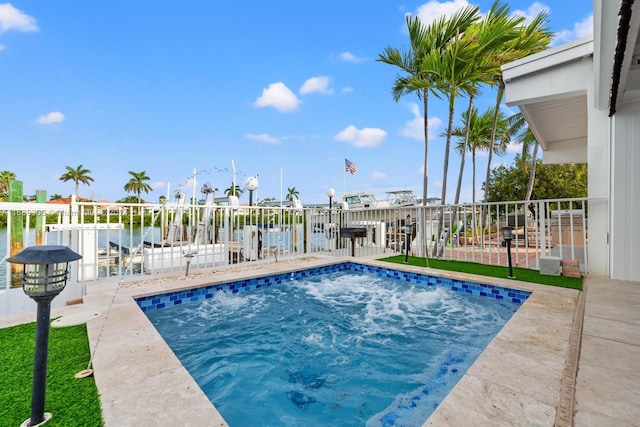 view of pool featuring a water view and a patio area