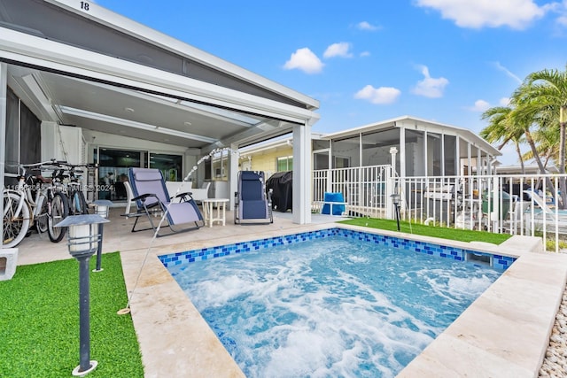 view of pool with a patio and a sunroom