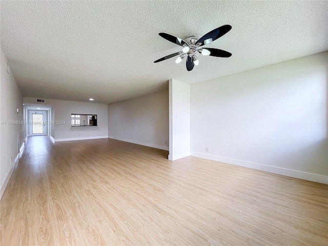 unfurnished living room with ceiling fan, a textured ceiling, and light wood-type flooring