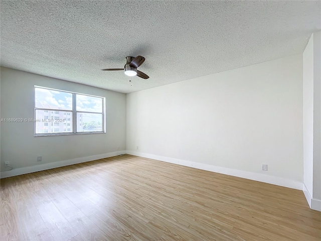 spare room with ceiling fan, light hardwood / wood-style floors, and a textured ceiling