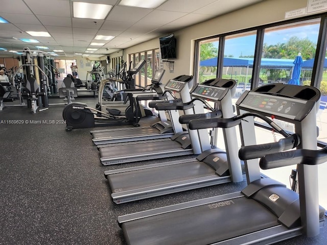 exercise room with a paneled ceiling