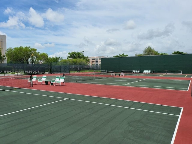 view of tennis court with basketball hoop