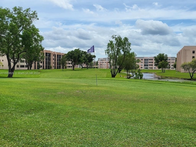 view of home's community featuring a yard and a water view