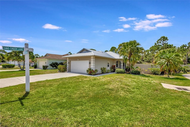 single story home featuring a garage and a front lawn