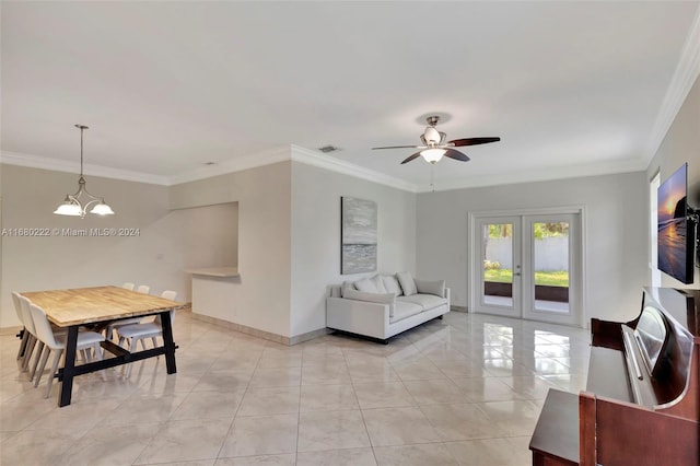 living room with french doors, ceiling fan with notable chandelier, and crown molding