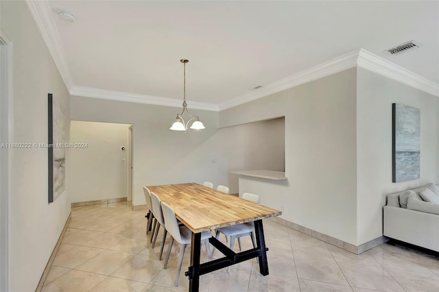 tiled dining room with a chandelier and ornamental molding