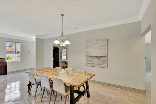 dining space with light tile patterned flooring, a notable chandelier, and ornamental molding