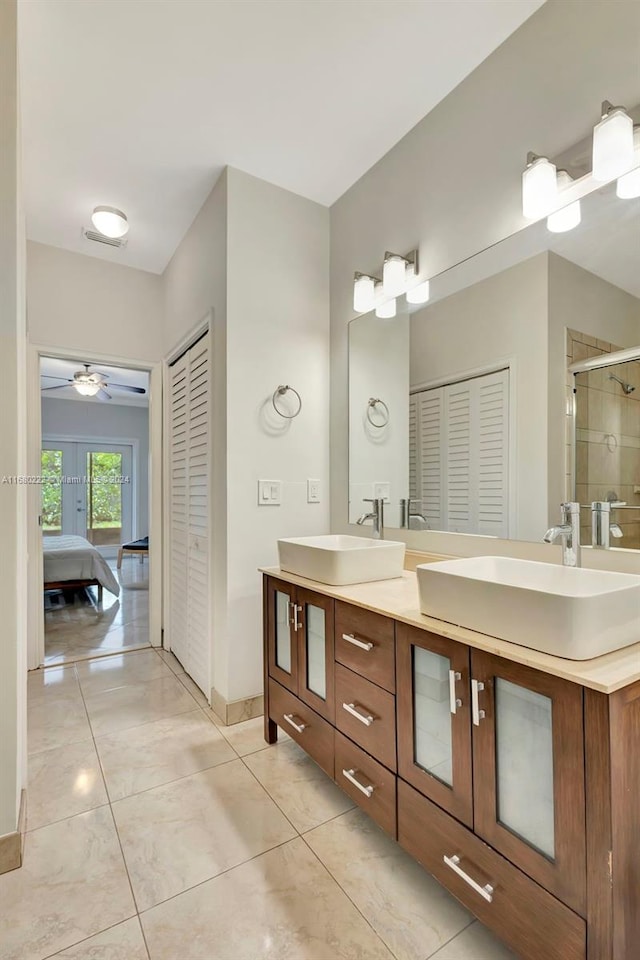 bathroom with vanity, tile patterned flooring, ceiling fan, and a shower with shower door