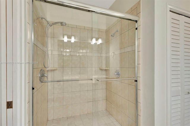 bathroom with a shower with door