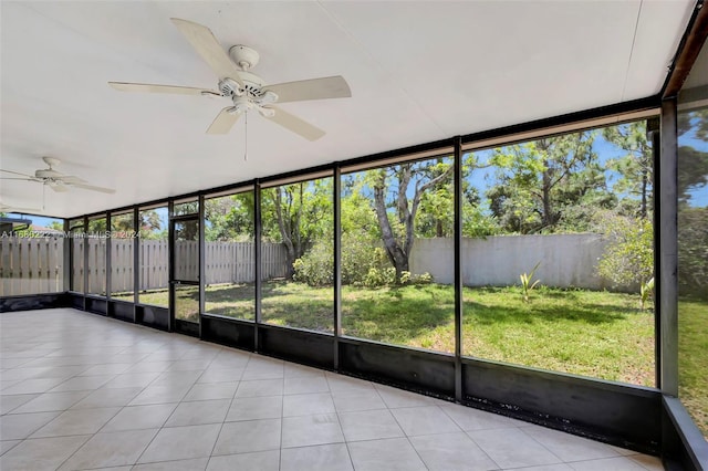 unfurnished sunroom with a wealth of natural light and ceiling fan