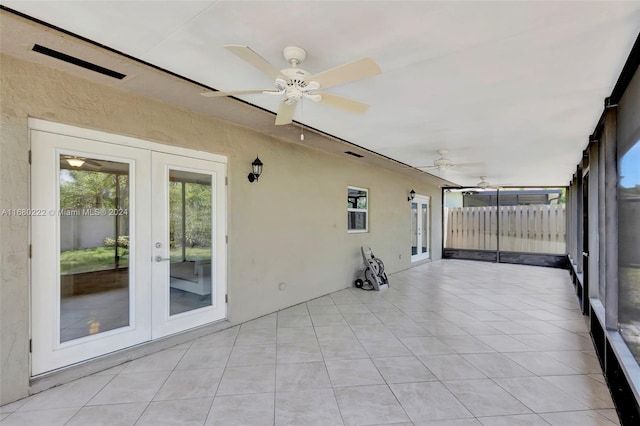 unfurnished sunroom with french doors and ceiling fan