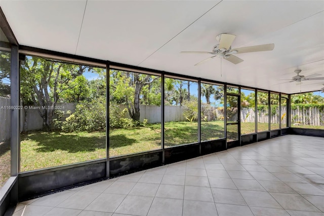 unfurnished sunroom featuring a wealth of natural light and ceiling fan