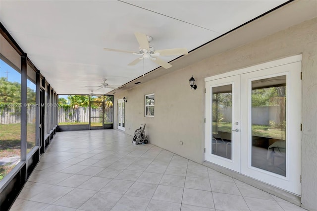 unfurnished sunroom with french doors and ceiling fan