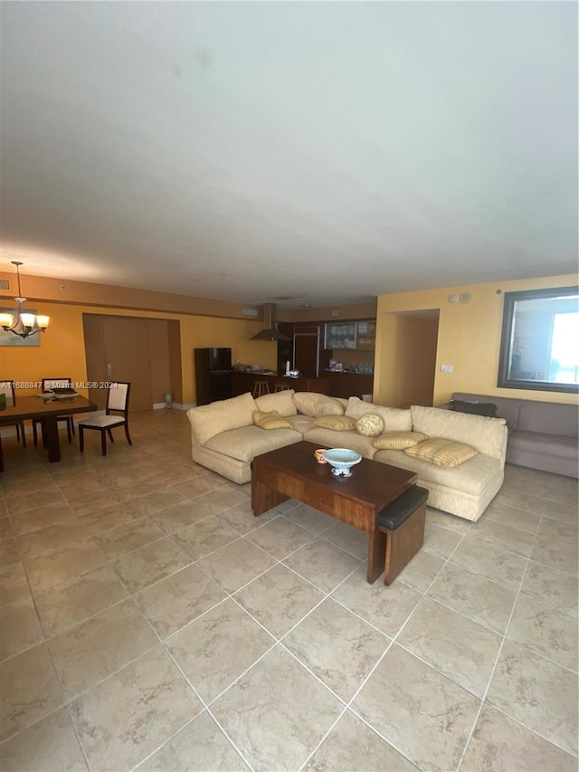 living room with a notable chandelier and light tile patterned flooring