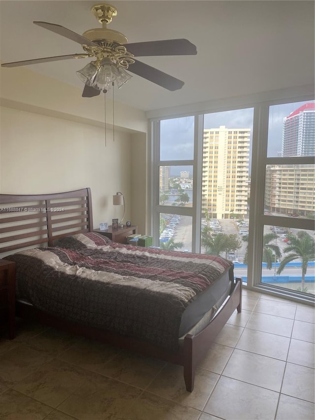 tiled bedroom with access to outside and ceiling fan