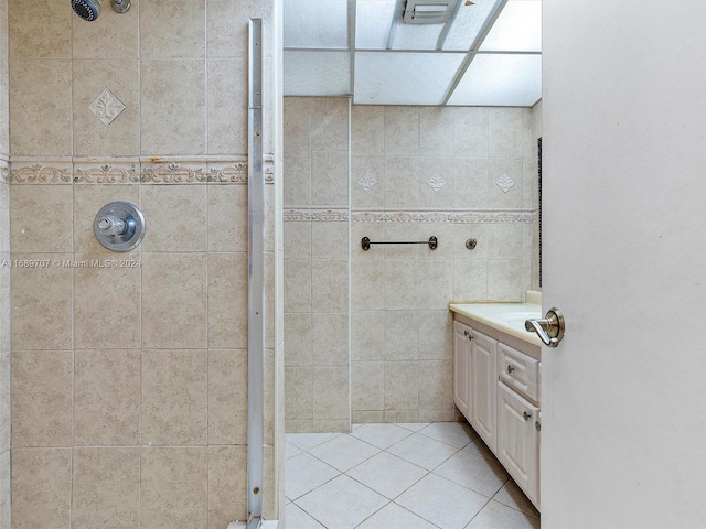 bathroom with vanity, tile patterned floors, and tiled shower