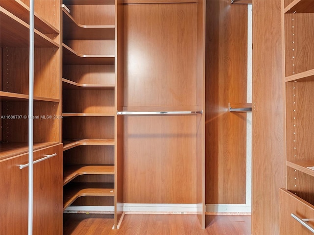 spacious closet featuring hardwood / wood-style floors