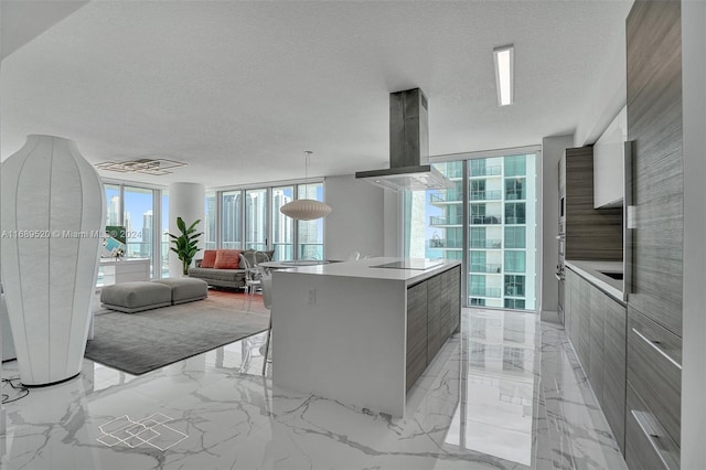 330 Sunny Isles Blvd Unit 5-2207, Sunny Isles Beach, FL 33160 - kitchen with modern cabinets, a spacious island, light marble finish floors, light countertops, and expansive windows