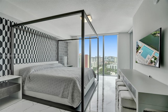 bedroom featuring floor to ceiling windows and a textured ceiling