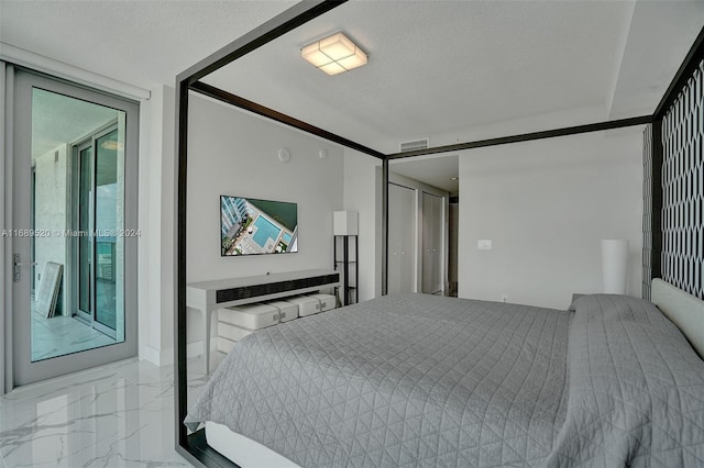 bedroom with access to outside and a textured ceiling