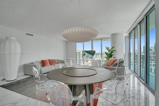 330 Sunny Isles Blvd Unit 5-2207, Sunny Isles Beach, FL 33160 - dining space featuring marble tiled floors and a textured ceiling