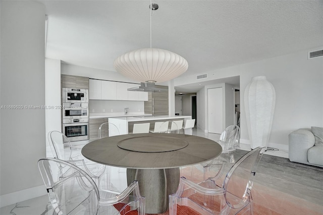 dining space with a textured ceiling