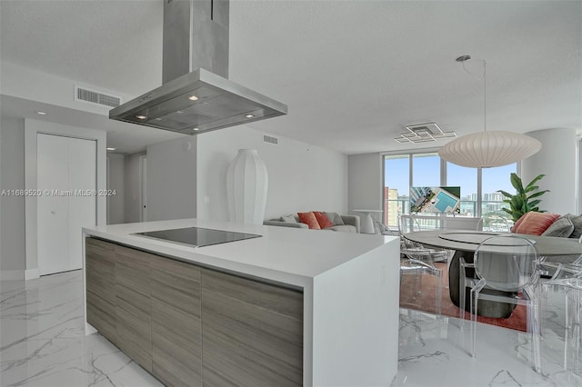 kitchen featuring a center island, a textured ceiling, wall chimney exhaust hood, and black electric stovetop