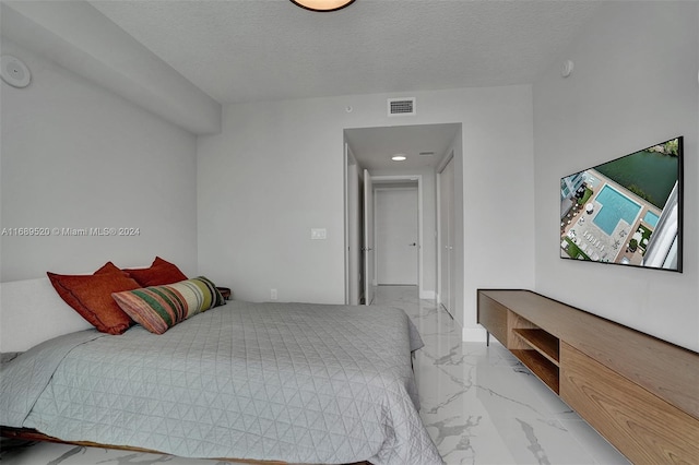 330 Sunny Isles Blvd Unit 5-2207, Sunny Isles Beach, FL 33160 - bedroom with light marble finish floors and a textured ceiling