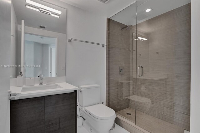 330 Sunny Isles Blvd Unit 5-2207, Sunny Isles Beach, FL 33160 - bathroom featuring toilet, vanity, and a shower stall