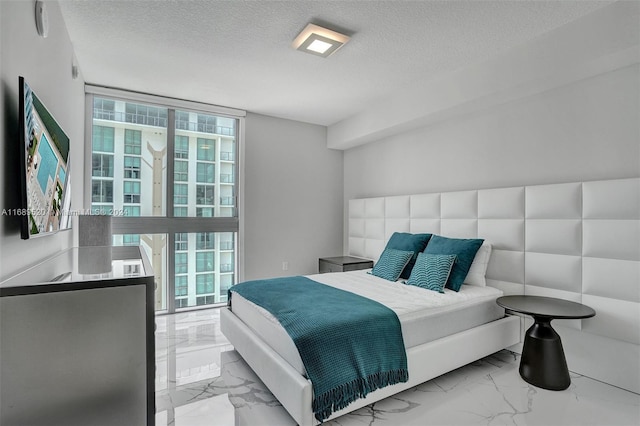330 Sunny Isles Blvd Unit 5-2207, Sunny Isles Beach, FL 33160 - bedroom with marble look tiles and a textured ceiling