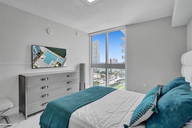 330 Sunny Isles Blvd Unit 5-2207, Sunny Isles Beach, FL 33160 - bedroom with light marble finish floors, a textured ceiling, and floor to ceiling windows